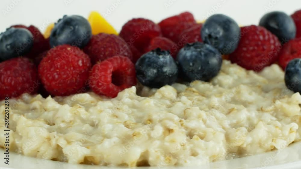 A healthy breakfast oatmeal on a plate with assorted fruits and berries, raspberries, peaches, blueberries rotates 360 on a white background. Close-up of a ready-to-eat breakfast in the morning.
A healthy breakfast oatmeal on a plate with assorted fruits and berries, raspberries, peaches, blueberries rotates 360 on a white background. Close-up of a ready-to-eat breakfast in the morning.