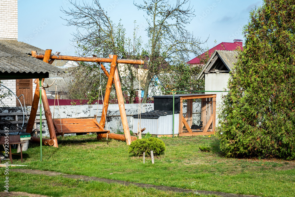 Wooden swing in the garden on backyard. Wooden swing in the garden on backyard.