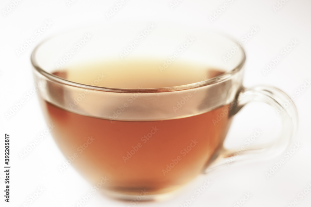 Glass of tea in transparent cup with morning lights bokeh macro retro style Glass of tea in transparent cup with morning lights bokeh macro retro style