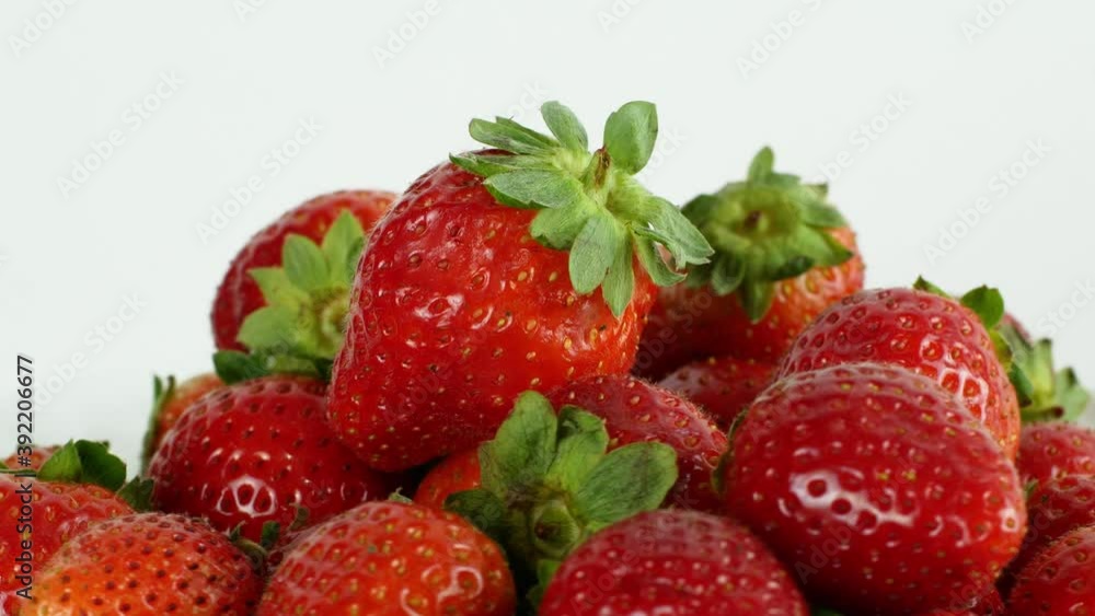 Juicy ripe exotic strawberry rotates on a white background 360. Eco fruits and berries summer. Juicy ripe exotic strawberry rotates on a white background 360. Eco fruits and berries summer.