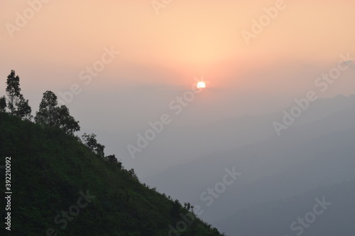 Natural Sunset Sunrise Over Field Or Meadow. Bright Dramatic Sky And Dark Ground. Countryside Landscape Under Scenic Colorful Sky At Sunset Dawn Sunrise. Sun Over Skyline, Horizon. Warm Colours.