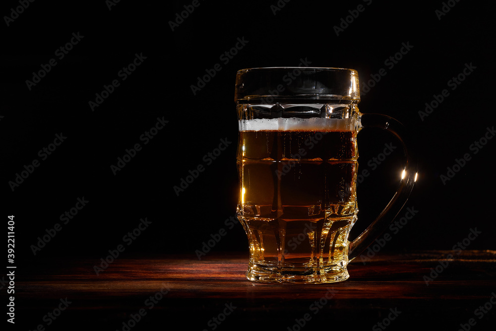Large glass mug of beer on dark background Large glass mug of beer on dark background