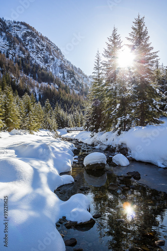 Il torrente nella valle imbiancata dalla neve - Val Brandet photo