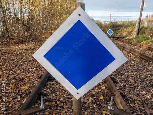 Wooden buffer stop with blue sign stop. The sign ending rail tracks