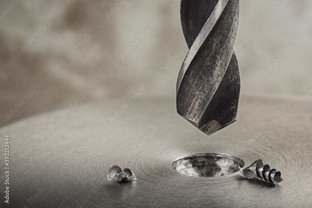 metal drill bit make holes in steel billet on industrial drilling machine. Metal work industry and locksmith work. metal drill bit make holes in steel billet on industrial drilling machine. Metal work industry and locksmith work.