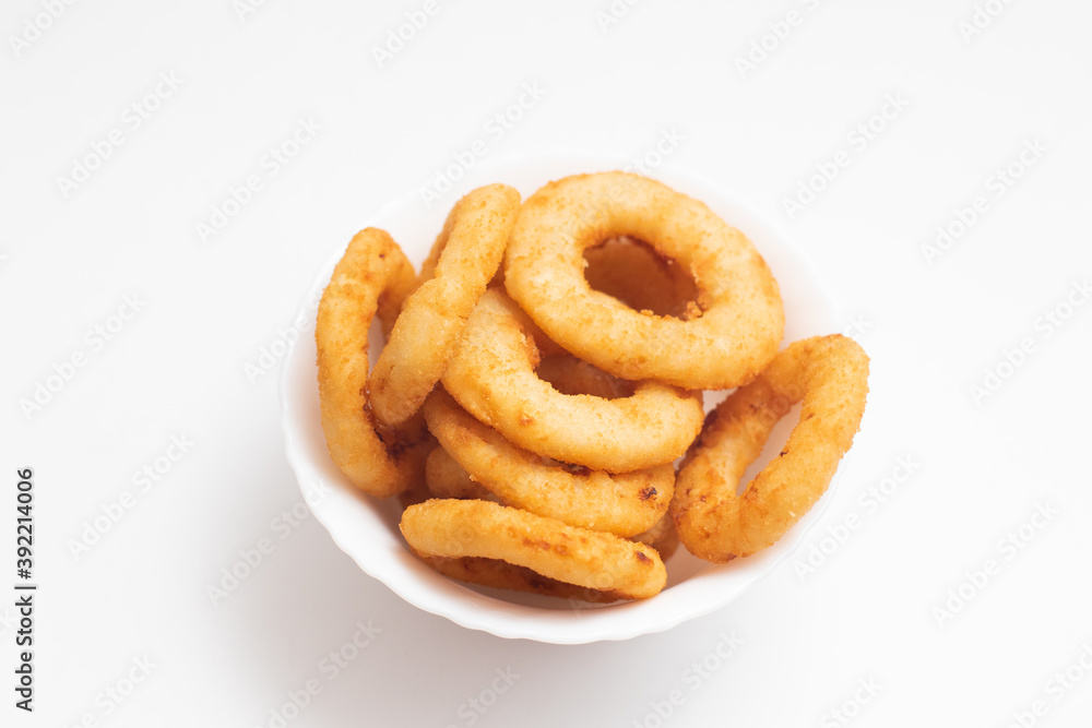 Fried onion rings in a white bowl