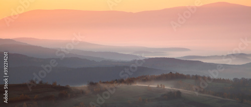 panorama of mountains in the fog at sunrise. autumn season