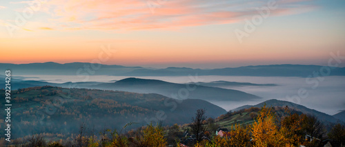 panorama of mountains in the fog at sunrise. autumn season
