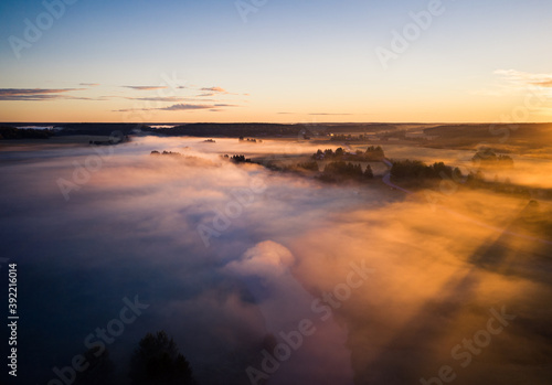 Aerial view rural landscape with fog and golden sunrise