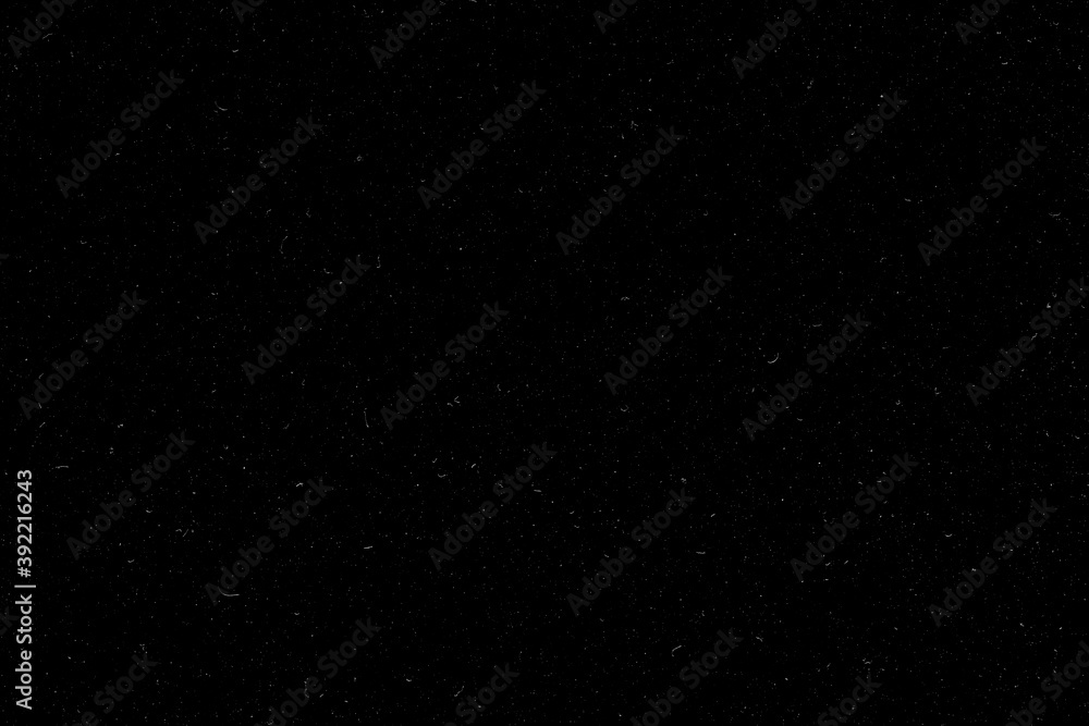 Real dust isolated on black background. Can be used as an additional layer for your project. Black dusty texture.