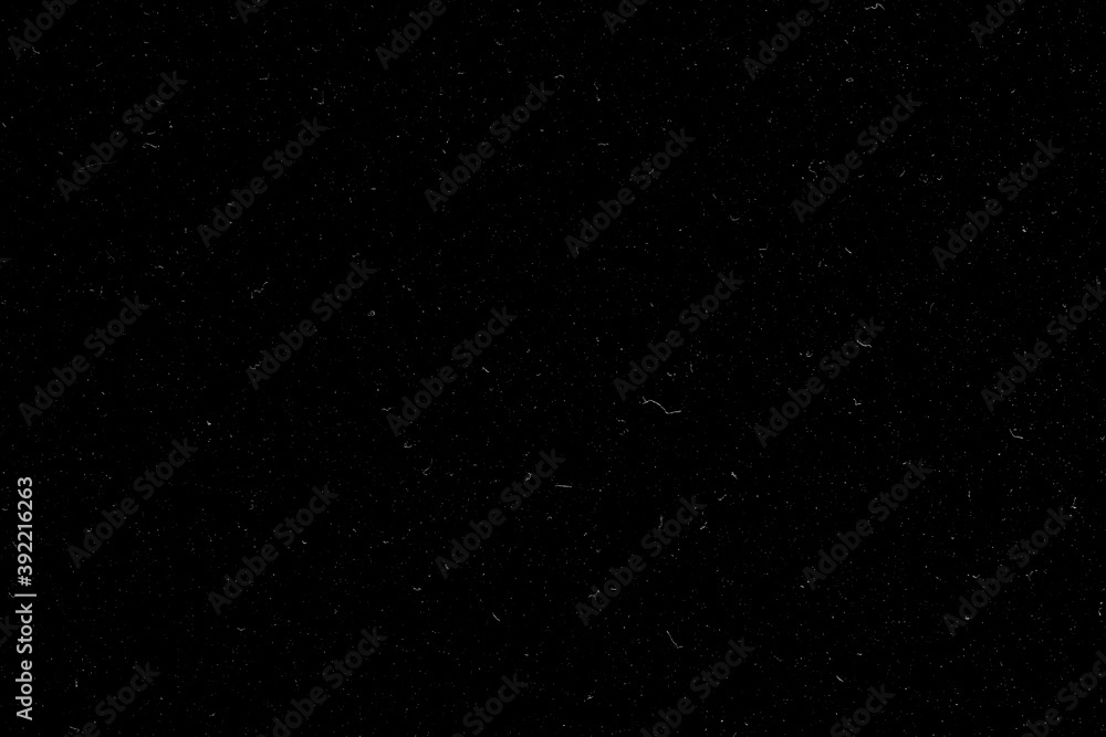 Real dust isolated on black background. Can be used as an additional layer for your project. Black dusty texture.