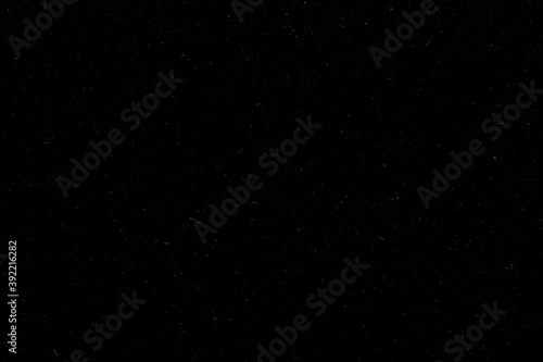 Real dust isolated on black background. Can be used as an additional layer for your project. Black dusty texture. © Artem Zarubin