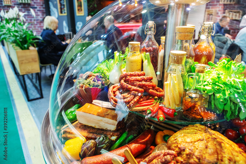 Meat and vegetables in a farm store. Glass showcase with products