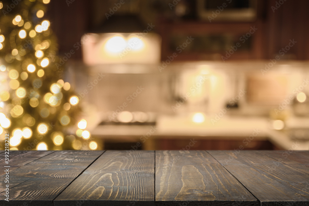 Wooden countertop and blurred kitchen with Christmas tree. Background for display or montage your products. Wooden countertop and blurred kitchen with Christmas tree. Background for display or montage your products.