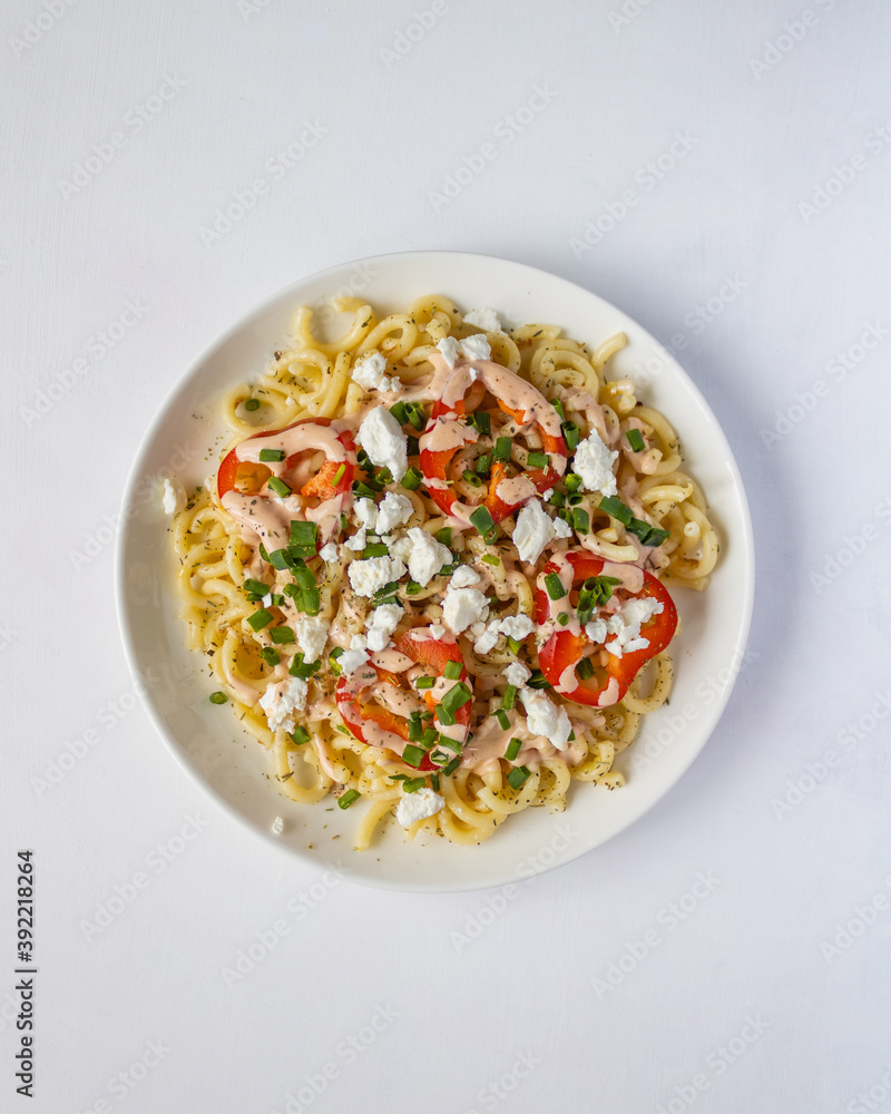 White plate with pasta on light desk White plate with pasta on light desk