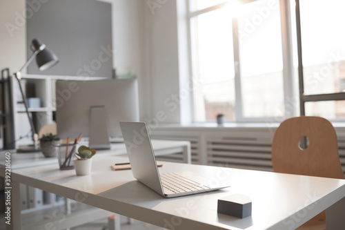 Light workplace with computer for business person at empty modern office