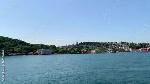 Footage of Emirgan area of Istanbul by Bosphorus strait. Beautiful scene. It is a sunny summer day. Camera moves forward. photo