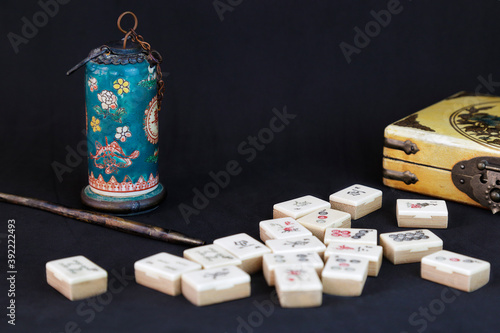 Canvas Print Antique opium pipe and other chinese objects (mahjong and a yellow box) against