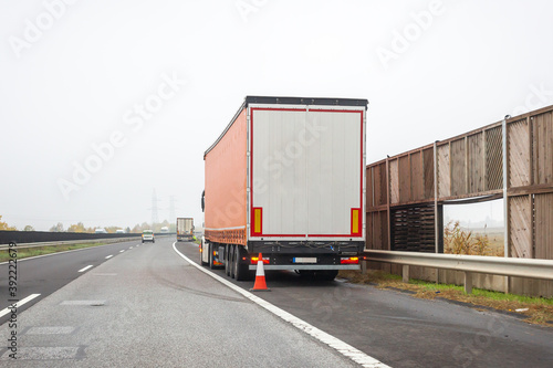 Faulty truck on emergency stopping lane on roadside. Problem with vehicle on highway. Industrial transportation concept, export, import, logistic