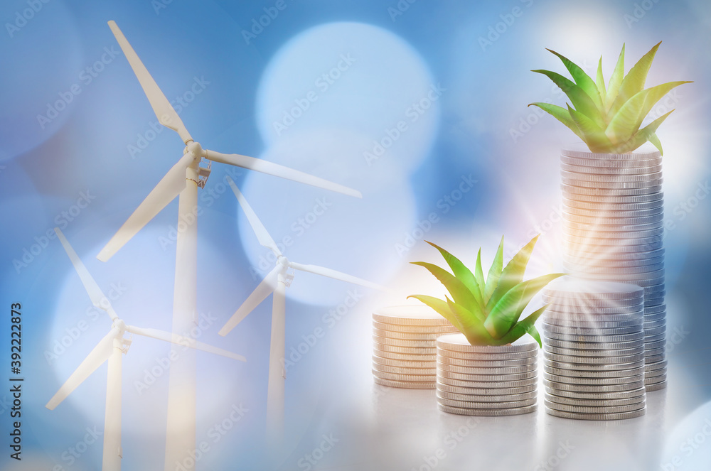 Renewable clean energy investment for sustainability  concept and alternative energy economic growth idea. Growing money plant on stack of coins and arrow with turbine and power background - obrazy, fototapety, plakaty 