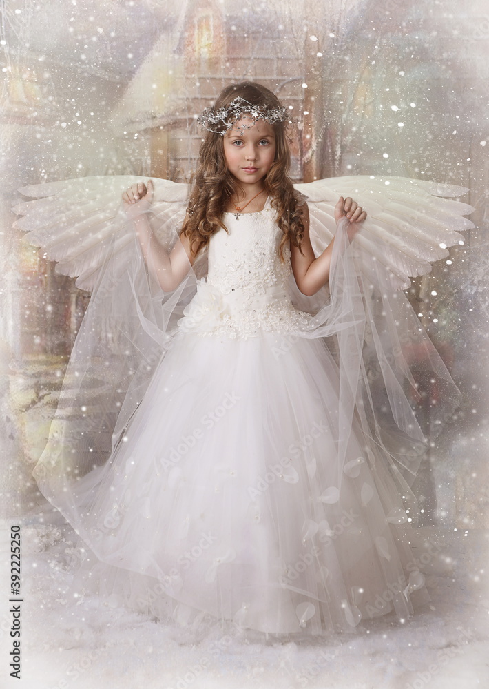 Small angel. The girl with wings. Falling snow 