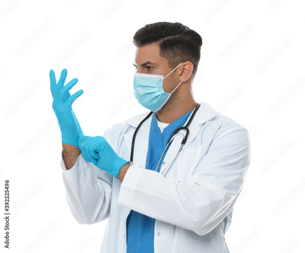 Doctor in protective mask putting on medical gloves against white background Doctor in protective mask putting on medical gloves against white background