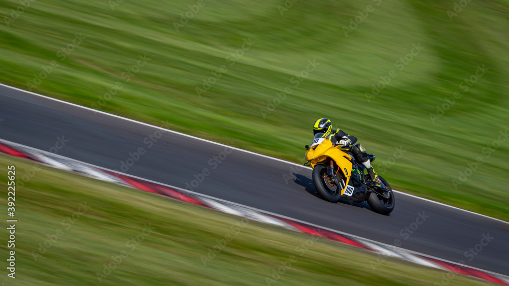 Fototapeta premium A panning shot of a racing bike cornering on a track.
