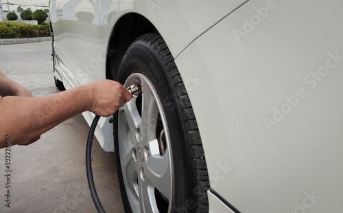 Hand of the technician who is cheering to the tire.