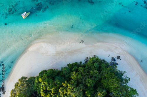 Aerial view tropical island with white sand beach and blue clear water and granite stones, speedboats above coral reef. Similan Islands, Thailand