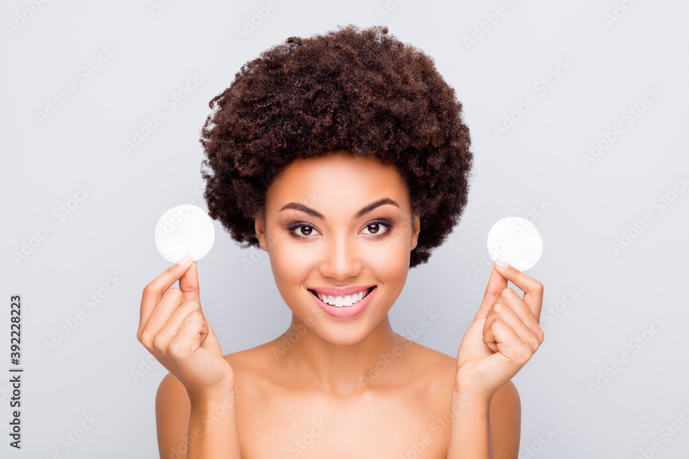 Close-up portrait of nice attractive charming cheerful cheery wavy-haired girl holding in hands fresh cotton pads cleansing facial tonic isolated on light white gray color pastel background