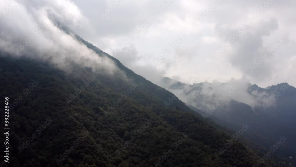 Flying over mountains in the clouds Flying over mountains in the clouds