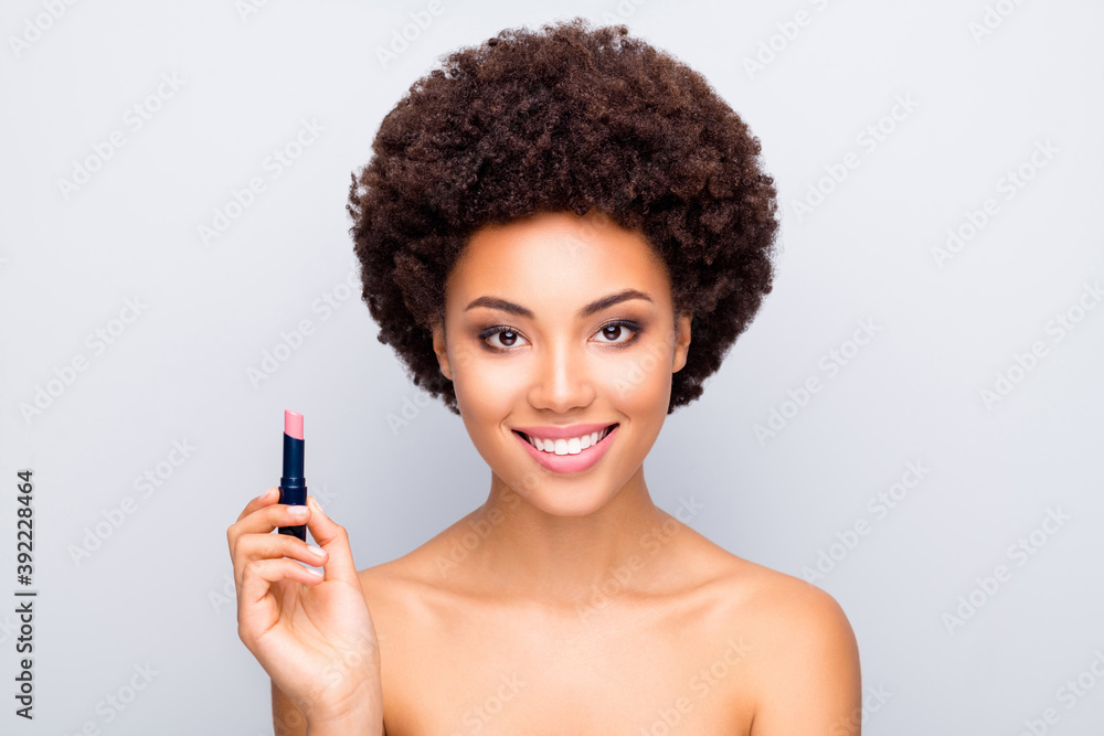 Close-up portrait of nice attractive charming cheerful wavy-haired girl with clean clear shine skin holding in hands new product natural lip balm isolated on light white gray color pastel background - obrazy, fototapety, plakaty 