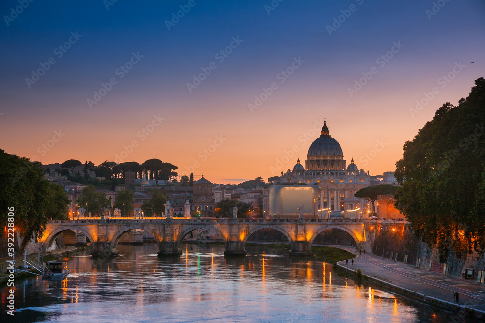 Tiber embankment with Ponte Sant Angelo bridge and St Peter Basilica in Vatican Rome Italy