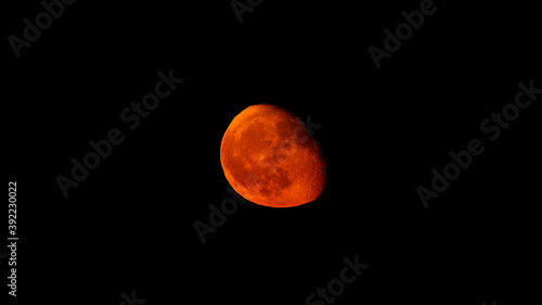 Moonrise, real color, 84% visibility of the moon on black sky dark background