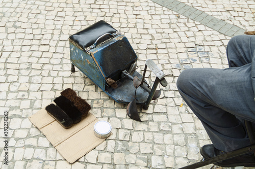 tools of a shoe shine on the cobblestones of a street in Porto, Portugal photo