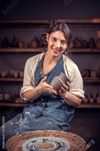 Pottery master demonstrates the finished clay product in a pottery workshop. Handcraft. photo