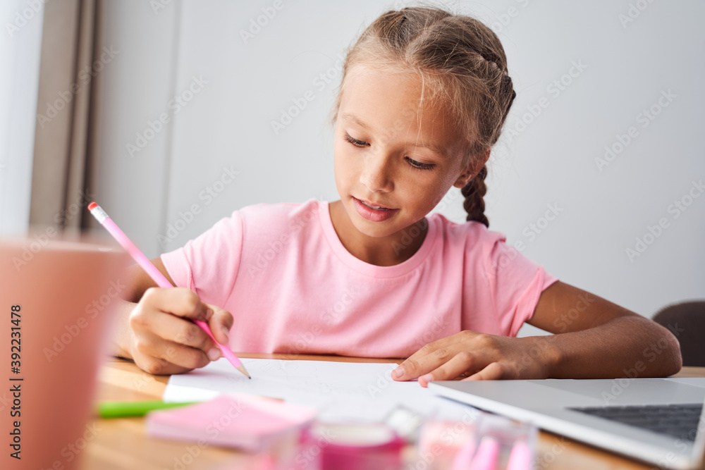 Child holding crayons and painting Child holding crayons and painting