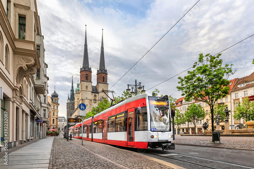 Halle  Saale   Germany. Red tram going on Hallmarkt square in front of Marktkirche church in old town