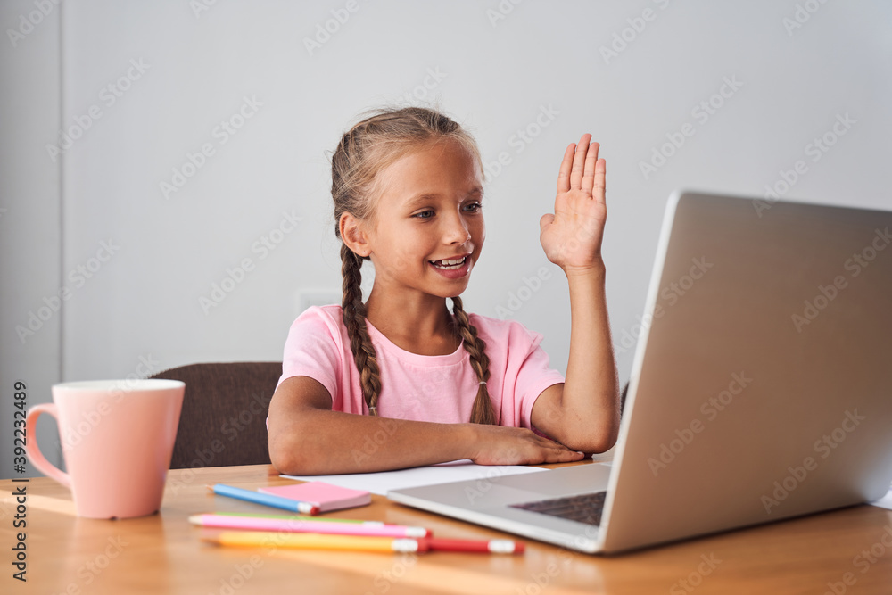 Girl raising her hand to answering Girl raising her hand to answering