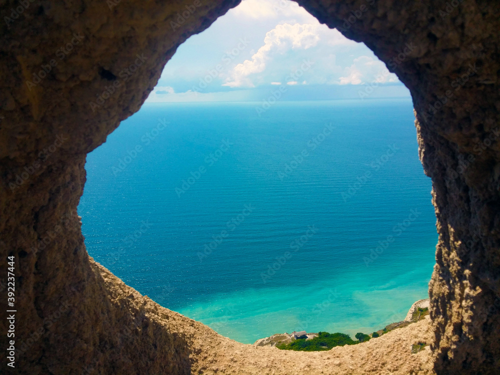 sea view through the rock on a summer sunny day