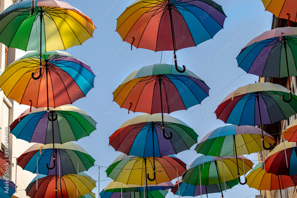 colorful umbrellas in the clouds as the main background