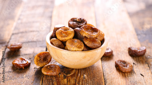 bowl of dried fig on wood background