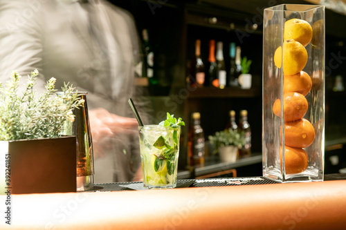 Mojito appena consegnato da un bartender al bancone photo