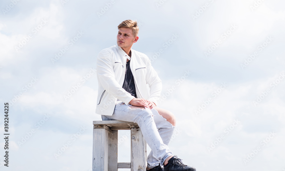 Be your own compass. Single guy sit on chair cloudy sky. Enjoying rest. Summer vacation. Travel and leisure. Outdoor adventure. Travelling and wanderlust. Male only vacation. Mancation
