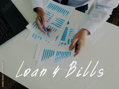 Financial concept meaning Loan 4 Bills with sign on the sheet. photo