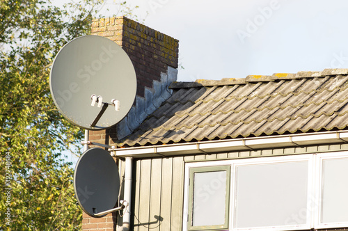 Slika na platnu Satellite dish on a facade of a house in the Netherlands