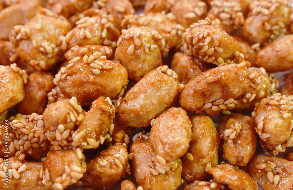 crispy sweet peanut coating syrup and dressing sesame in cup on table crispy sweet peanut coating syrup and dressing sesame in cup on table