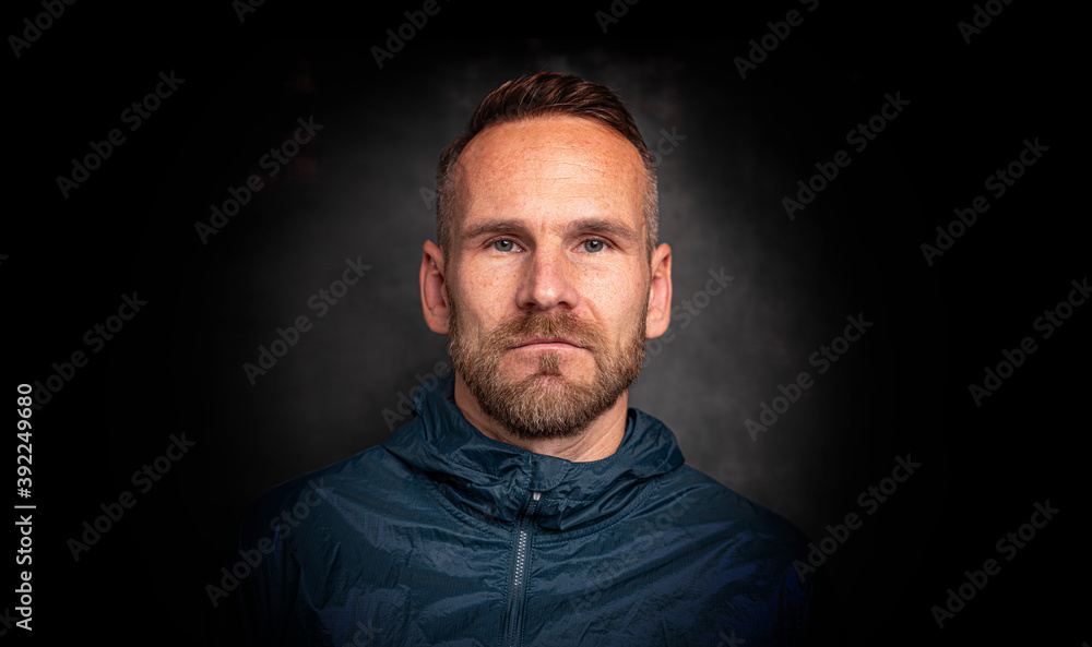 Handsome stylish man standing posing over dark background