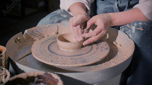 Ceramist woman making ceramic pot on the pottery wheel . Inspiration and creativity. Close-up. photo