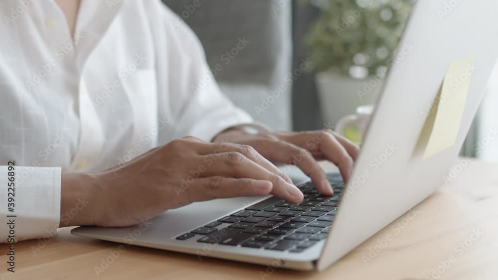 Close-up Hand woman Asian using a laptop computer typing work at home Close-up Hand woman Asian using a laptop computer typing work at home